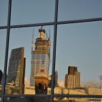 Reflection of tall London buildings in window