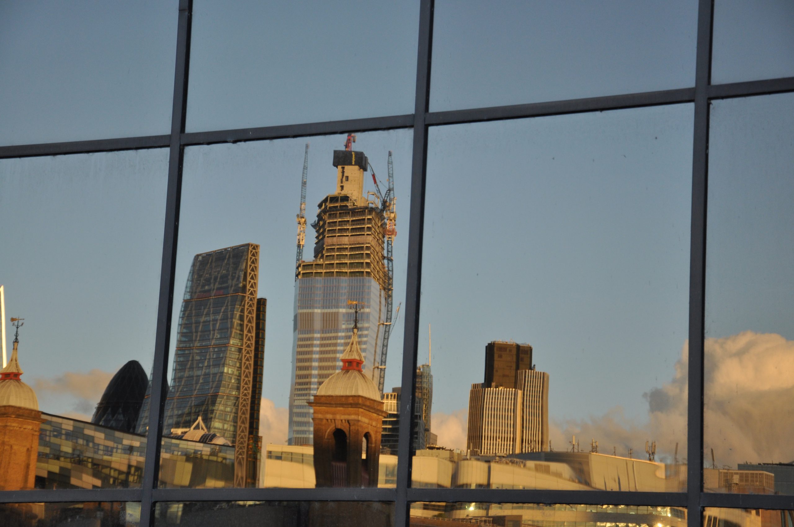 Reflection of tall London buildings in window